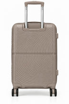 A hard-shell spinner suitcase in a warm taupe-beige color with a distinctive wavy, textured pattern on the front, featuring an extended telescopic handle and four wheels, shown against a plain white background.